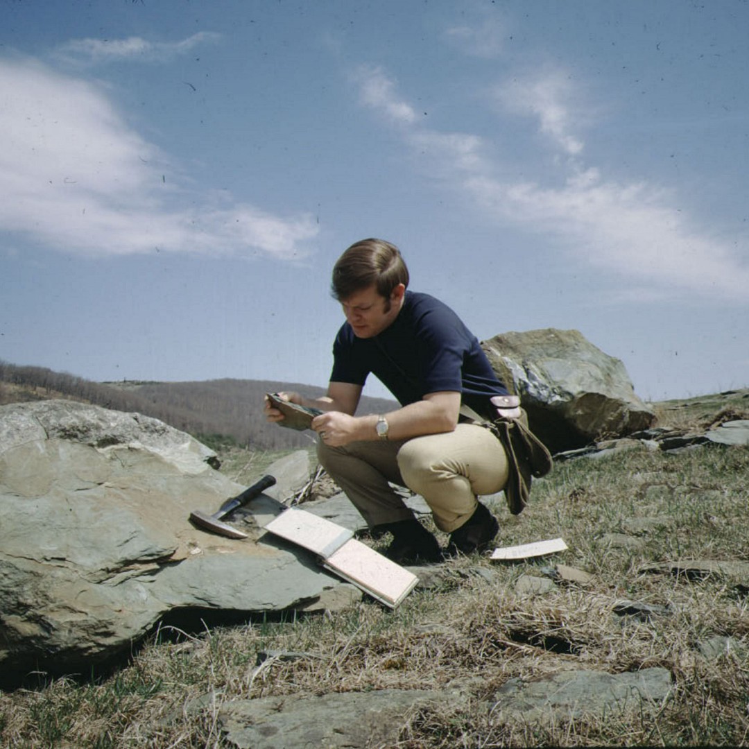 On this #throwbackthursday we go back to 1970 with a photo showing a #VirginiaEnergy geologist gathering field data on the rocks of the Catoctin Greenstone. Photos like these document our geologic work over the years.