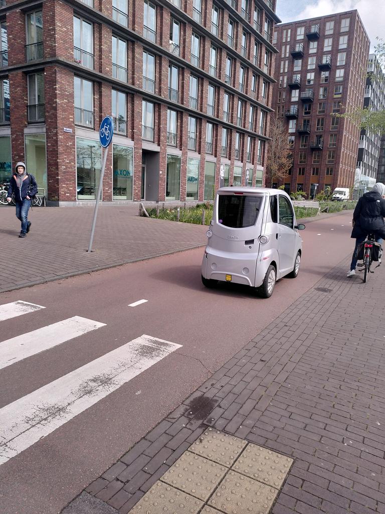 Micro cars sharing bike lanes in Amsterdam