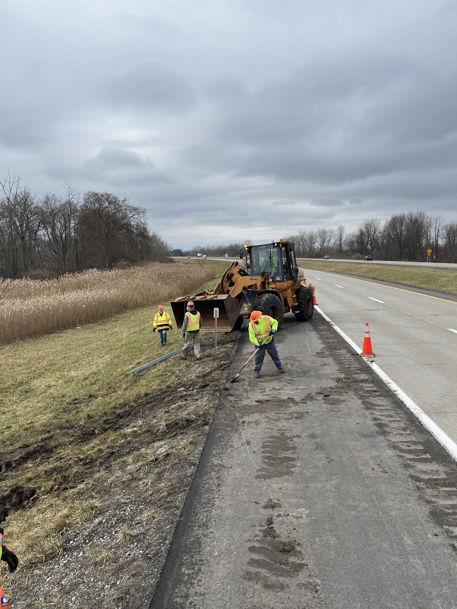 A crew from the North Erie County maintenance residency remove a large sign from the roadside along Interstate 990 in the town of Amherst