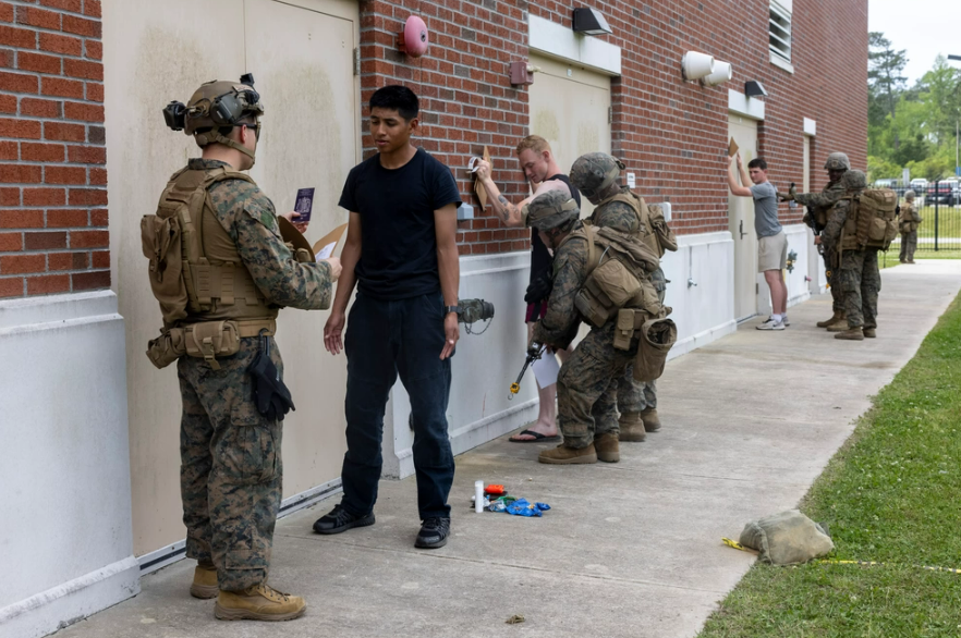 U.S. Marines with Romeo Battery, BN Landing Team 1/8, 24th MEU process role players during a noncombatant evacuation operation exercise on Stone Bay, Camp Lejeune, NC. The 24th MEU &amp; WSP ARG are conducting COMPTUEX, an exercise to determine their readiness to deploy. <a href="/USMC/">U.S. Marines</a> <a href="/24MEU/">24 Marines Unit</a>