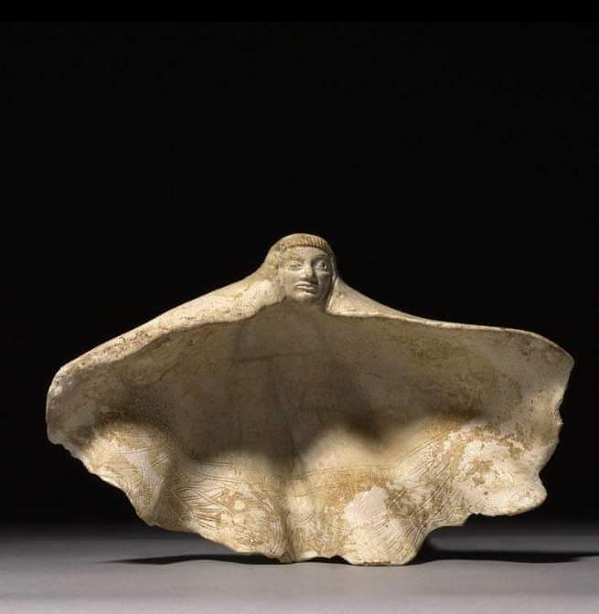Carved Grooved Clam Shell (700-600 BC), Vulci, Italy. A woman's face peeks out from this clam shell, and the waves on the shell's back are swirling like the woman's cloak blowing in the wind. The bark once held perfume or was used to mix makeup. The approximately 2,700-year-old…