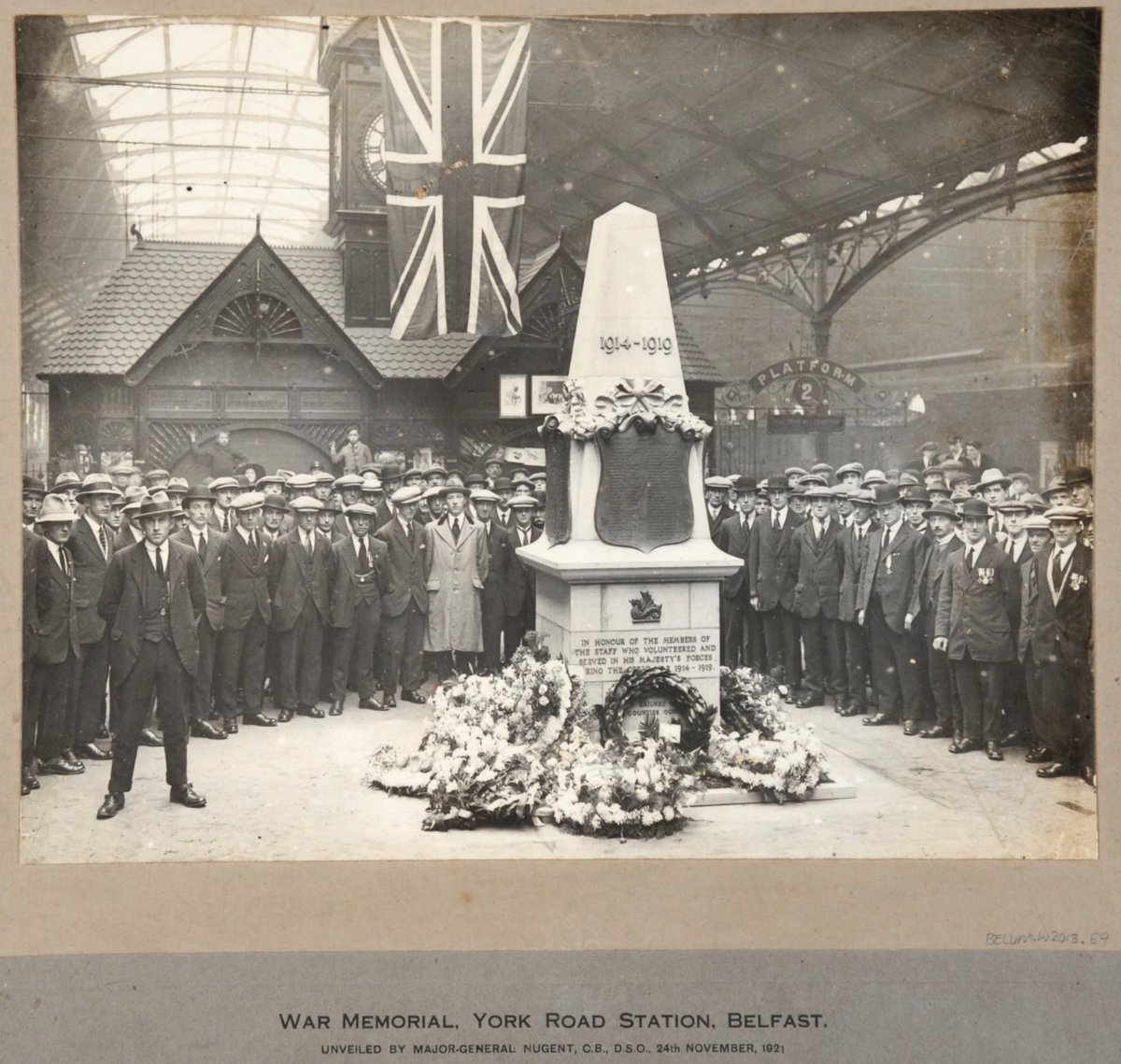 The unveiling of a war memorial by General Oliver Nugent at York Road Station, North Belfast, 24 November 1921. Eye-catching - the grave power of the veterans present, the boy hanging off the wall at the back, and the violence occurring simultaneously on the streets outside...