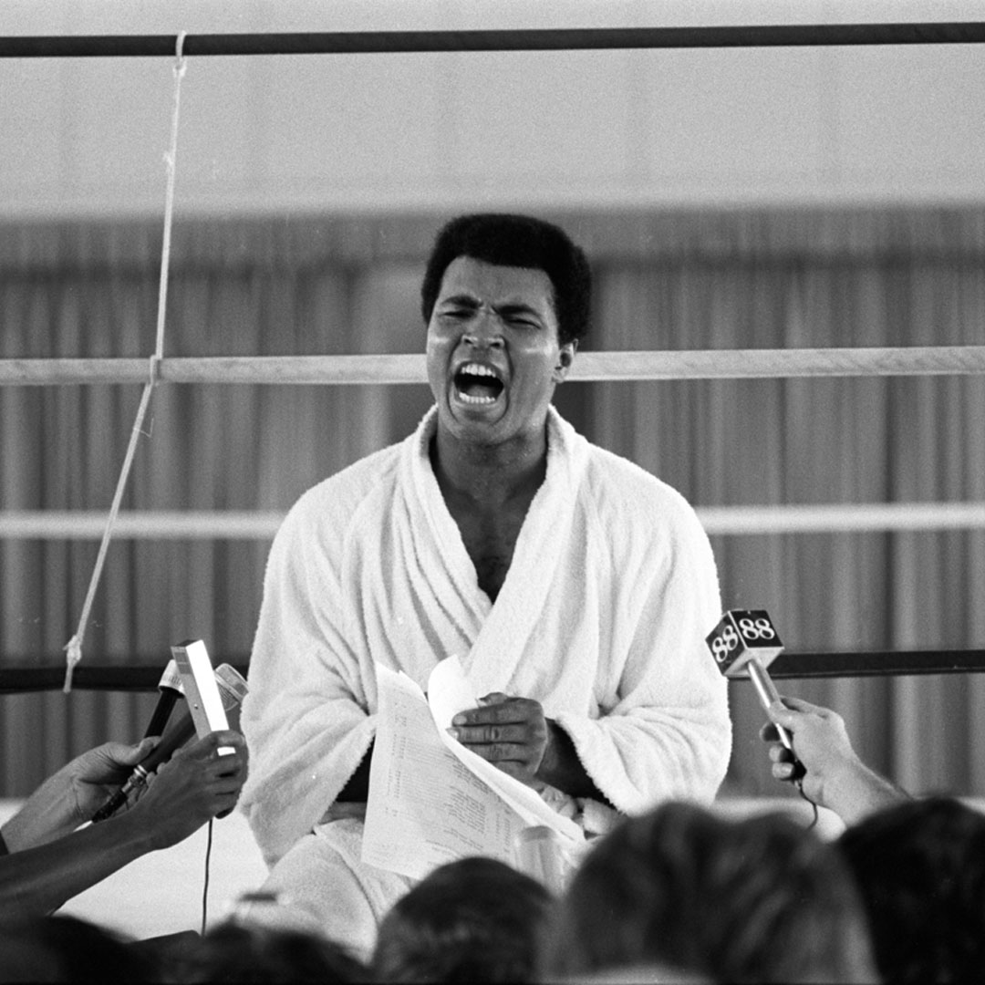 Muhammad Ali during an interview with the press while training before his fight vs George Foreman at the Salle de Congres in the presidential complex outside of Kinshasa. 📸: @LeiferNeil #MuhammadAli #Icon #PressInterview #ForemanFight #Kinshasa #NeilLeifer #Photography