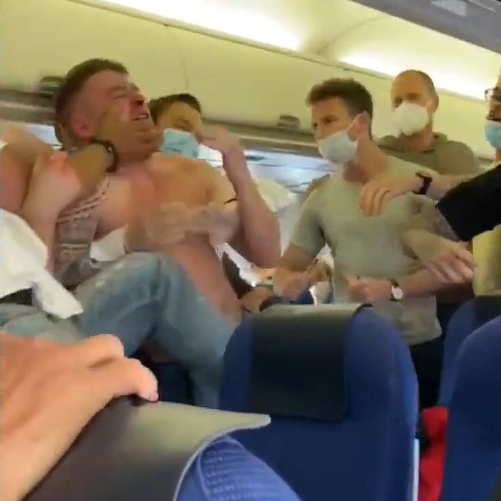 John Terry being restrained after he saw Josh McEachran eating some free peanuts in first class