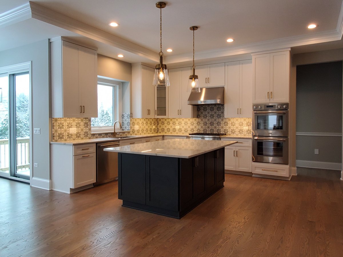 We love how the tile #backsplash pulls together the dark and light #kitchencabinets! Our #modelhome is open from 11 am - 5 pm at 4012 Alfalfa Ln #Naperville #newhome #newhomedesign #newhomebuilder #newhomeconstruction #homebuilder #customhomebuilder #kitcheninspo #kitchendesign
