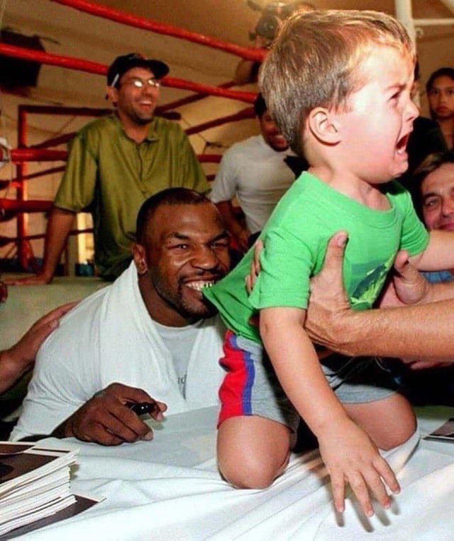 Mike Tyson and Jake Paul in 1999.