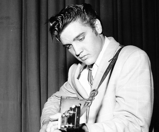 Elvis Presley playing guitar backstage in Houston, 1956