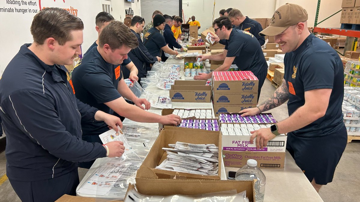 Sailors from @USNavy 's USS George H. W. Bush load boxes at @FoodbankSEVA , part of ship's effort to honor its namesake in this, the 100th anniversary year of his birth. 1,300 sailors worked at 77 locations, completing more than 3,000 hours of community service. @13NewsNow