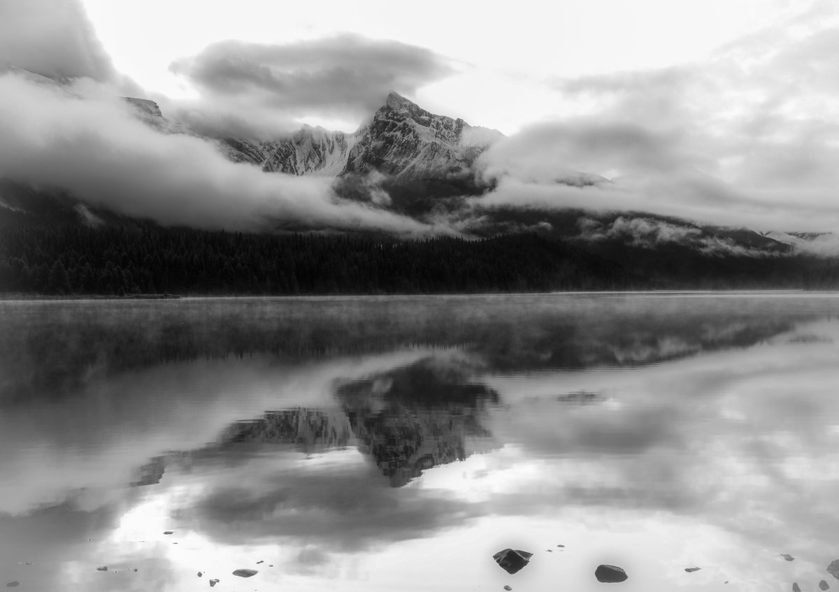 Moody mornings in the Canadian Rockies 🏔️ Reflecting on nature's beauty. #Mountains #NaturePhotography #CanadianRockies #BlackAndWhitePhotography dansproul.com/featured/malig…