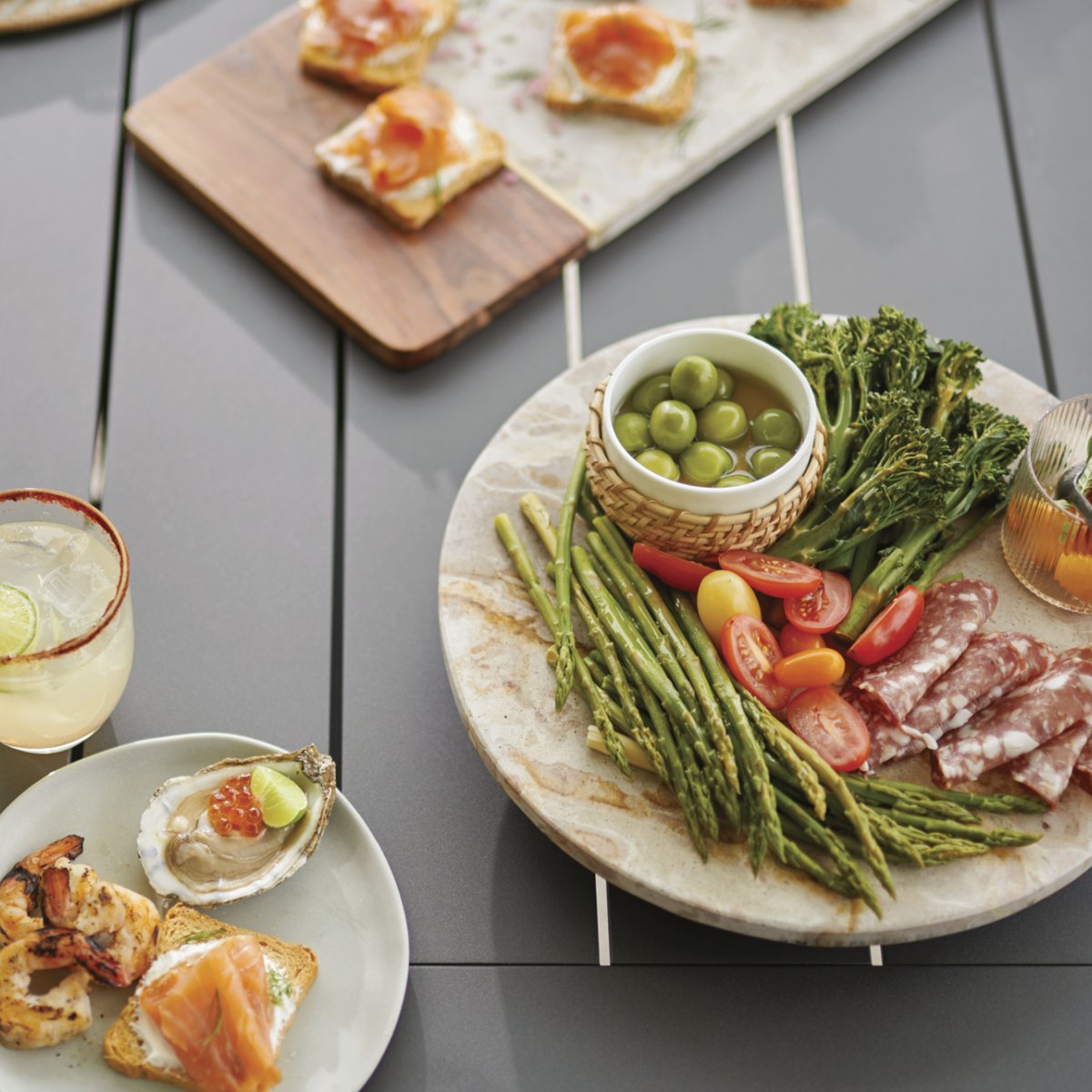 What are your charcuterie board must-haves? 
.
.
.
#outdoordesign #patiodesign #outdoorliving #patiofurniture #diningstyle #tablesetting #charcuterieinspo #charcuterieboard