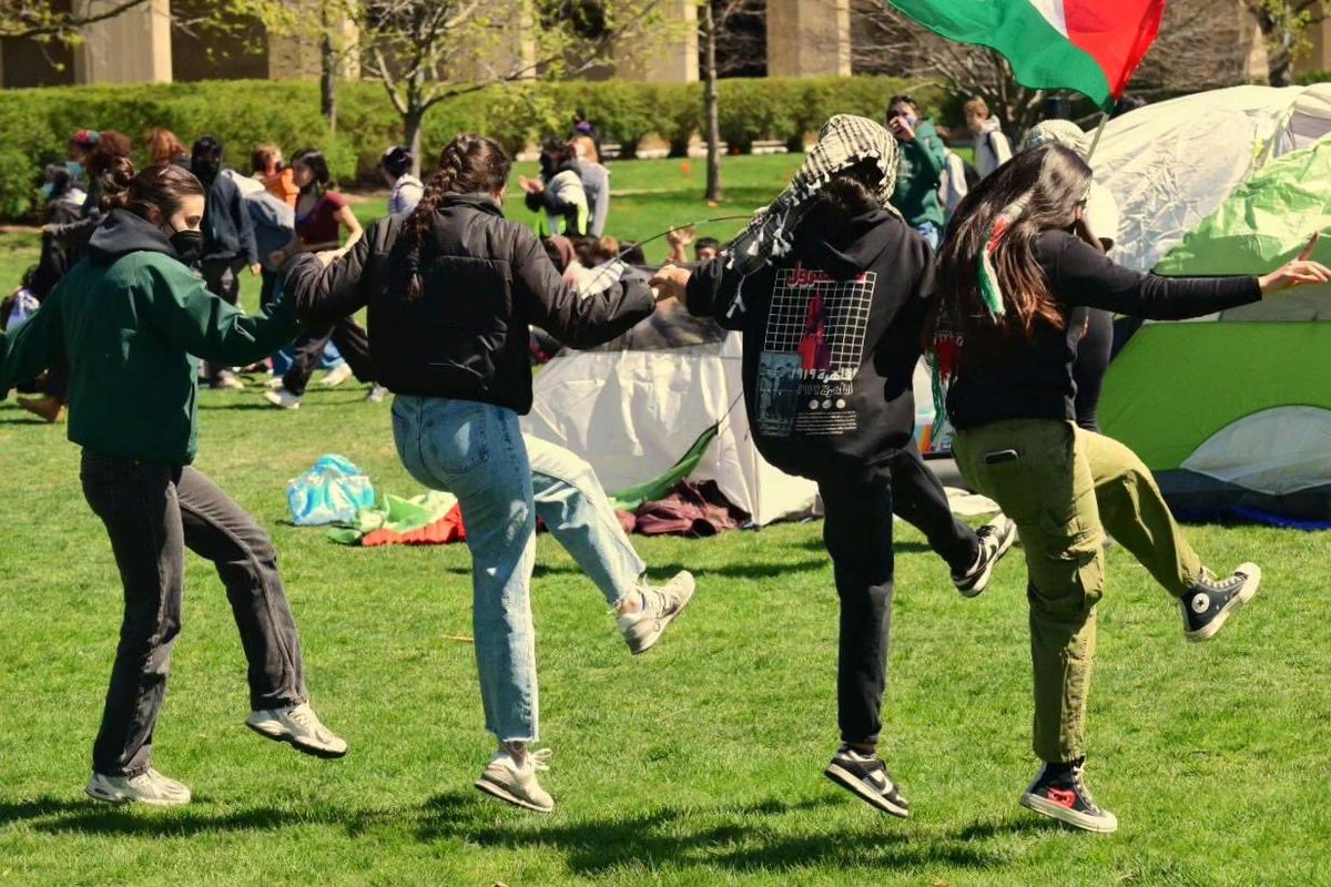 Scenes from Northwestern University's Gaza solidarity encampment. After early threats of arrest this morning, protesters stood their ground on Deering Meadow until campus police vehicles retreated. Reinforcements continue arriving, with a larger rally planned this evening.