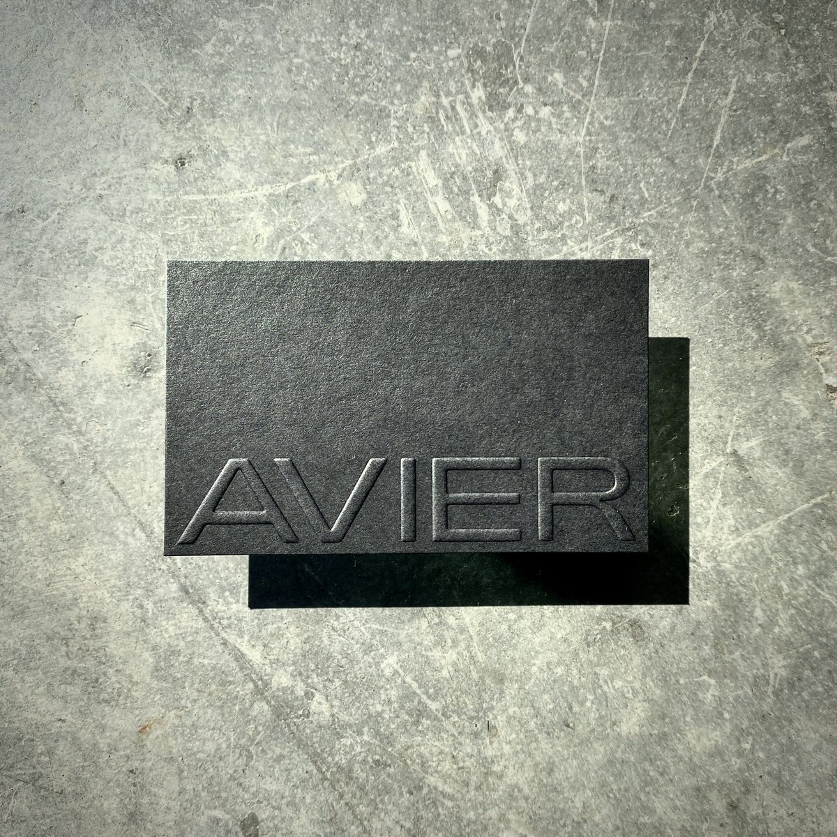 AVIER Business cards.
Blind Embossed logo front, White Foiled text back on Colorplan Ebony Black 270gsm and Duplexed to 540gsm card to hide the emboss on the back 

#avier #businesscards #businesscard #duplex #foil #foiling #emboss #embossing #colorplan #taylordpress