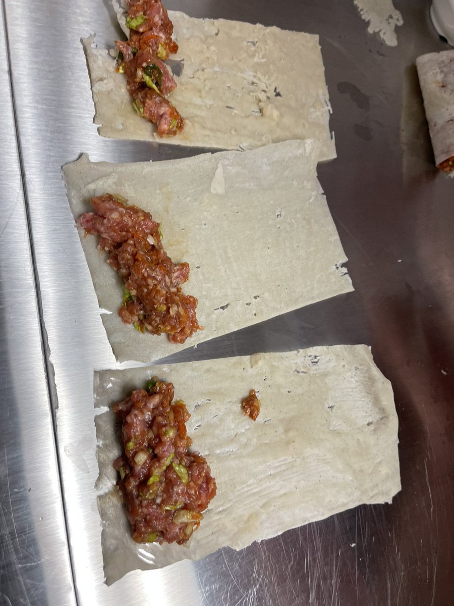 MmeDorval's tweet photo. A small team of students made lumpia and even made the gluten-free wrappers for them. They “painted” the batter onto a warm pan, pealed the sheet off and used a knife to trim them into uniformly sized wrappers. 🔗 Recipe link in bio. @SacredHeartOCSB #SacredHeartHospitality https://t.co/FAFBiFUpBA