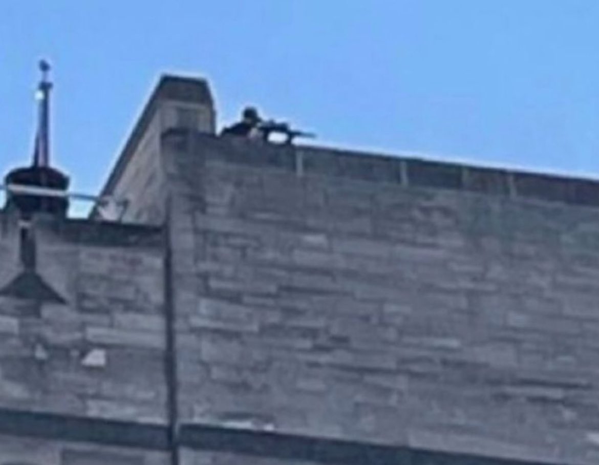 a sniper was spotted on the roof of a building aiming a gun at student protestors at the University of Indiana. what the hell is going on???