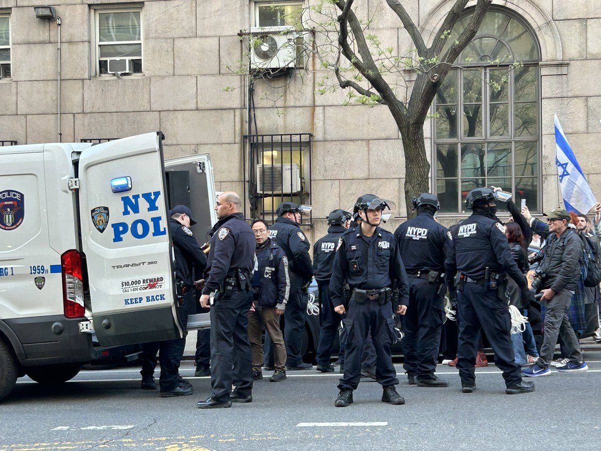 A man wearing a keffiyeh grabbed a metal pole and attempted to attack pro-Israel marchers. The man pictured talking to police told @NRO he was able to grab the pole out of the assailant’s hands before he could do any damage. Police led the assailant into a van.