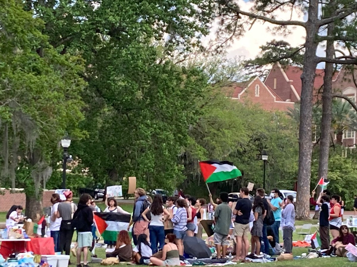 photos shared by colleagues/faculty comrades earlier today of the Gaza Solidarity protest at FSU. hearing that the numbers of students has ranged between 50-75 all day and the Zionist counter protestors have been a smaller but very vocal group. groups are separated by a barrier.