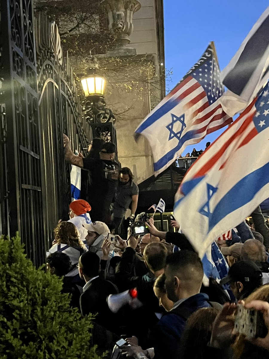 Columbia student’s “Epstein worked for Mossad” sign has enraged Israeli supporters to the point they’re trying to climb a 20 ft fence and raid campus themselves