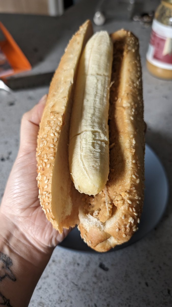 Partner says this is cursed and unhinged, but I believe I am a food pioneer. A banana is a hot dog shape. Peanut butter is delicious!!! Follow for more shit food tips!!!