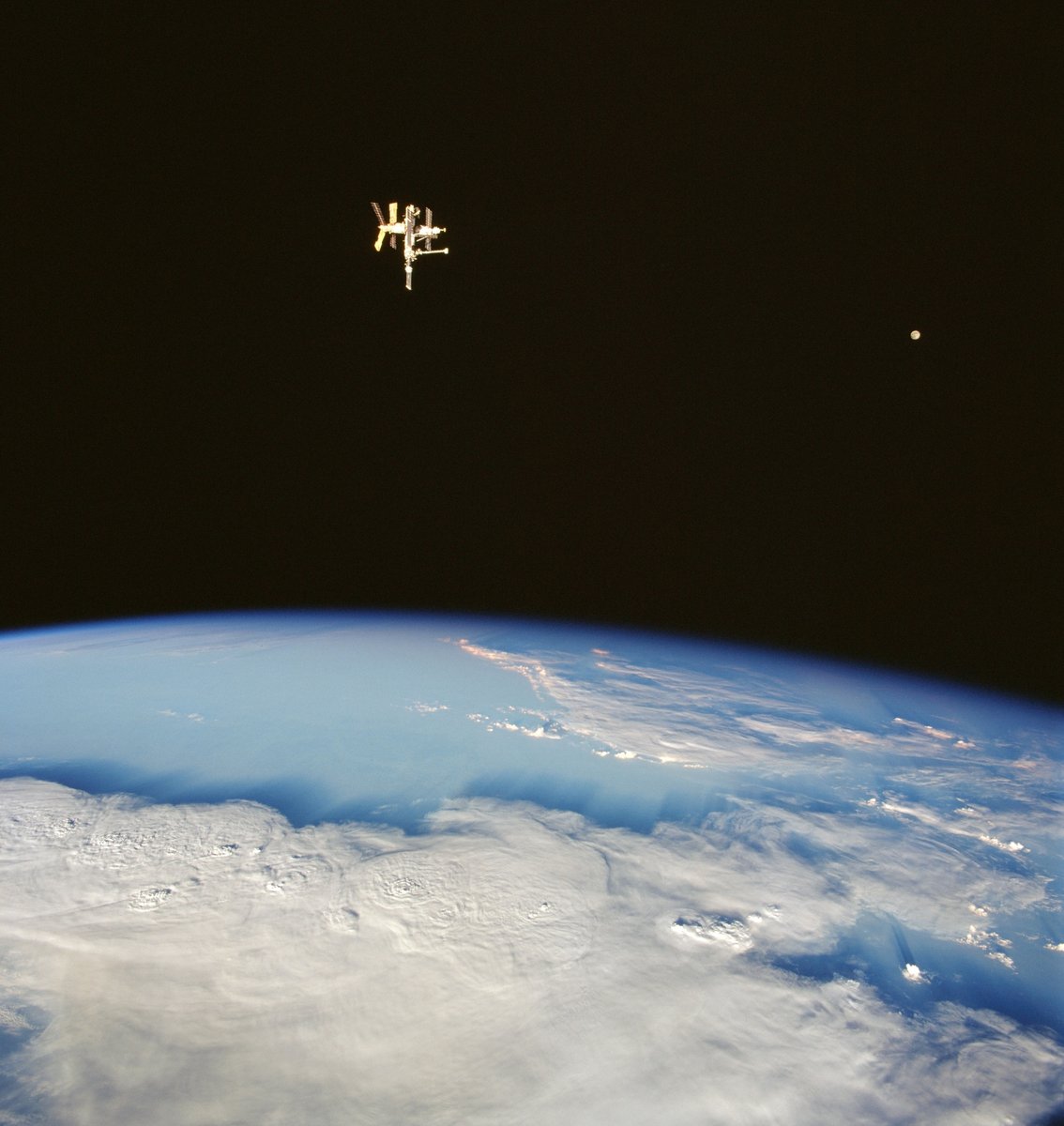 Mir orbital station and the Moon. Photograph from the Space Shuttle Discovery, 1998.