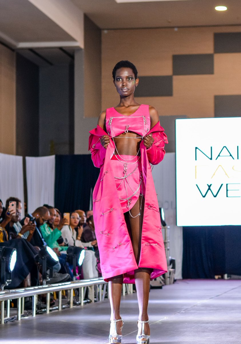From Miss DK, 3-piece ensemble with a draped asymmetric skirt, cropped satin top and embellished overcoat in vibrant pink made a bold statement at Nairobi Fashion Week 2022. #fashiontwt #kenya #africa #fashionweek