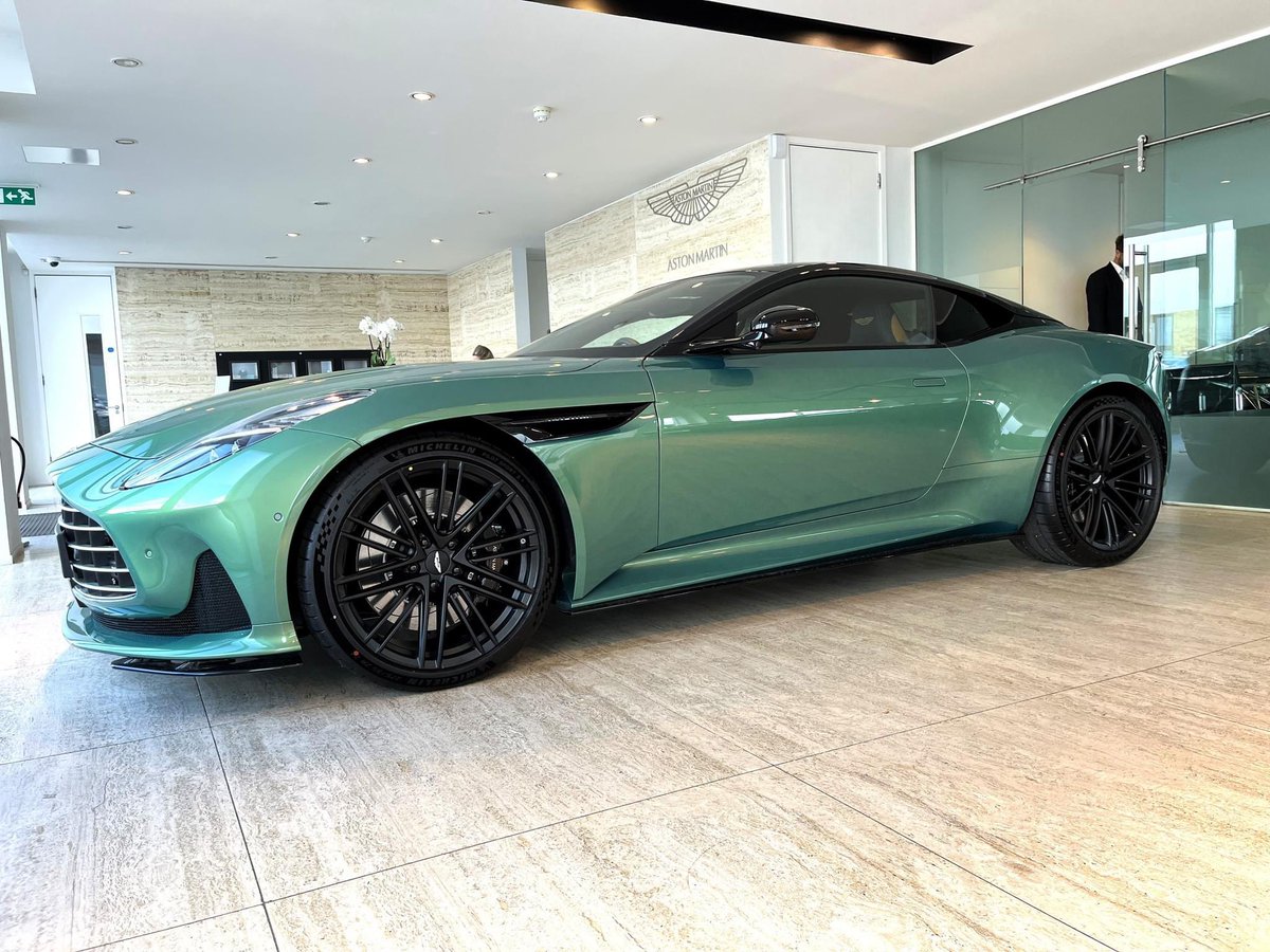 Stunning DB12 in Emerald Iridescent. * *Note the flowers growing out of the bonnet are a chargeable accessory and not standard equipment. #AstonMartin #HWM #DB12