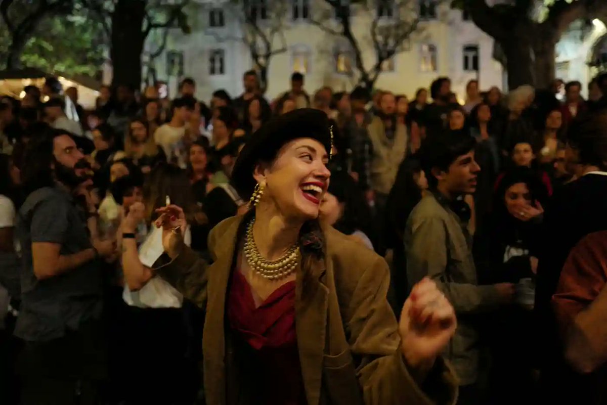 A woman dances in Carmo square, Lisbon as Portugal prepares to celebrate the 50th anniversary of the 1974 Carnation Revolution 🇵🇹 Photograph: Pedro Nunes/Reuters