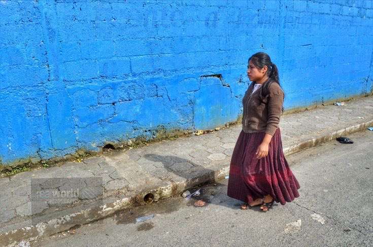 A woman walks down a Coban street. Guatemala, Central America. Gary Moore photo. Real World Photographs. #photojournalism #world #guatemala #centralamerica #malmo #sweden #women #coban #people #places #realworldvideo #photography #garymoorephotography #realworldphotographs #nikon