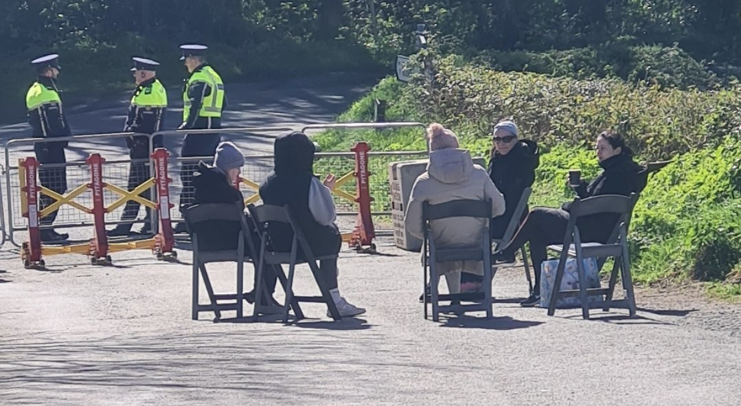 Hi all. This now Iconic photo is where we were 11 days ago.5 local young mother's sat around peacefully protesting and chatting about hundreds of young men being dumped into a field right where they live.#Newtownmountkennedy . Intimidation and bullying began minutes after this…