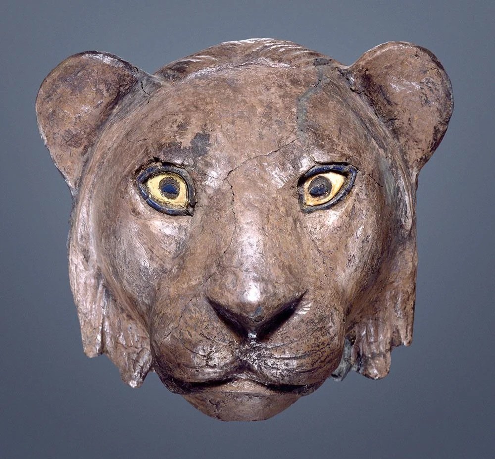 Sumerian lioness head sculpture made from silver, with shell and lapis lazuli inlays for eyes. Found in the tomb of Puabi at the Royal Cemetery of Ur, Iraq. Thought to be a finial on the arm of a chair. Dated to the First Dynasty of Ur (26th - 25th century BCE) #FindsFriday