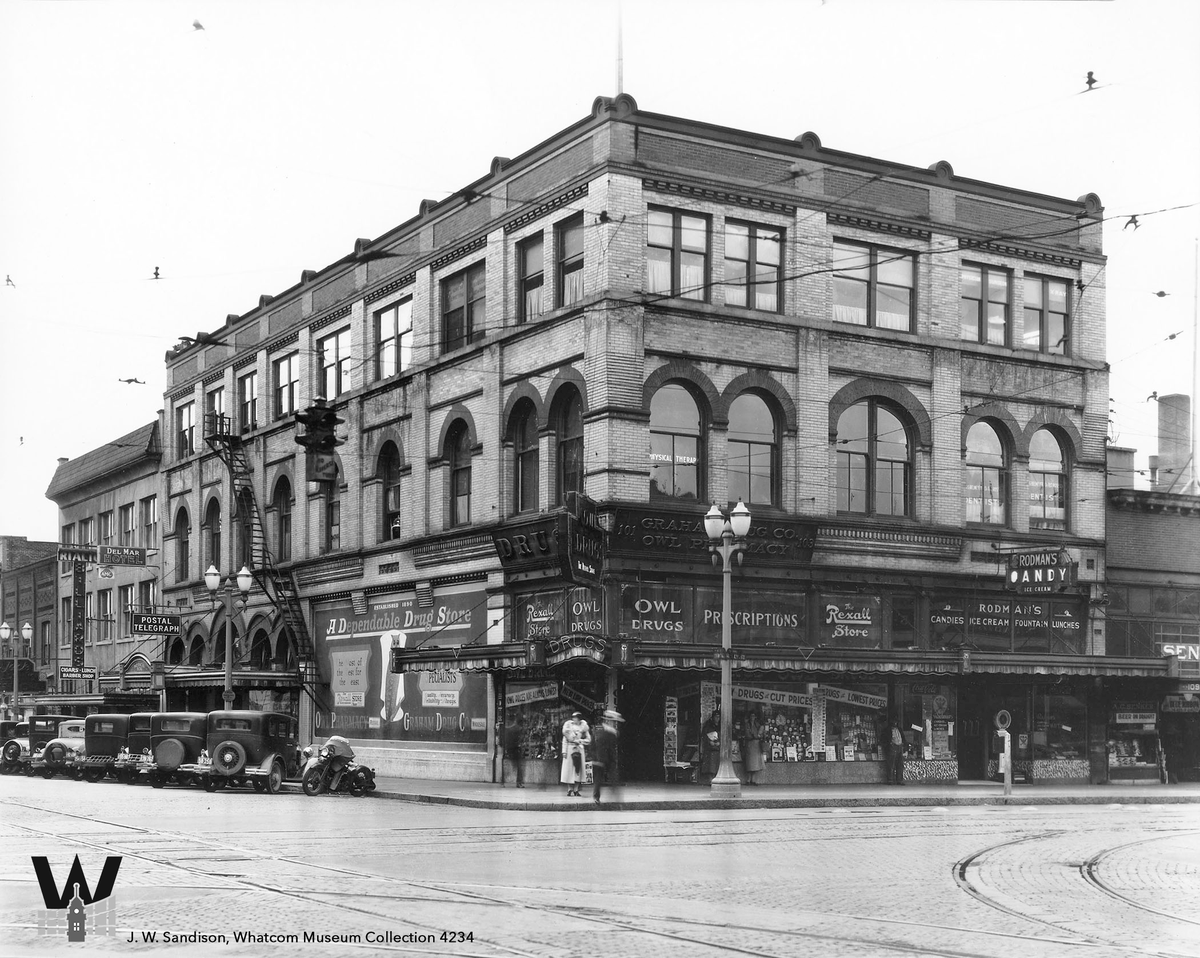 1923 flashback! J.W. Sandison's photo features the historic Fischer Block at Holly & Cornwall. Designed in 1896 by Alfred Lee, it housed Owl Pharmacy before expanding in 1923.  This building is now home to the Green House. #WhatcomMuseum #JWSandison #FlashbackFriday #Bellingham