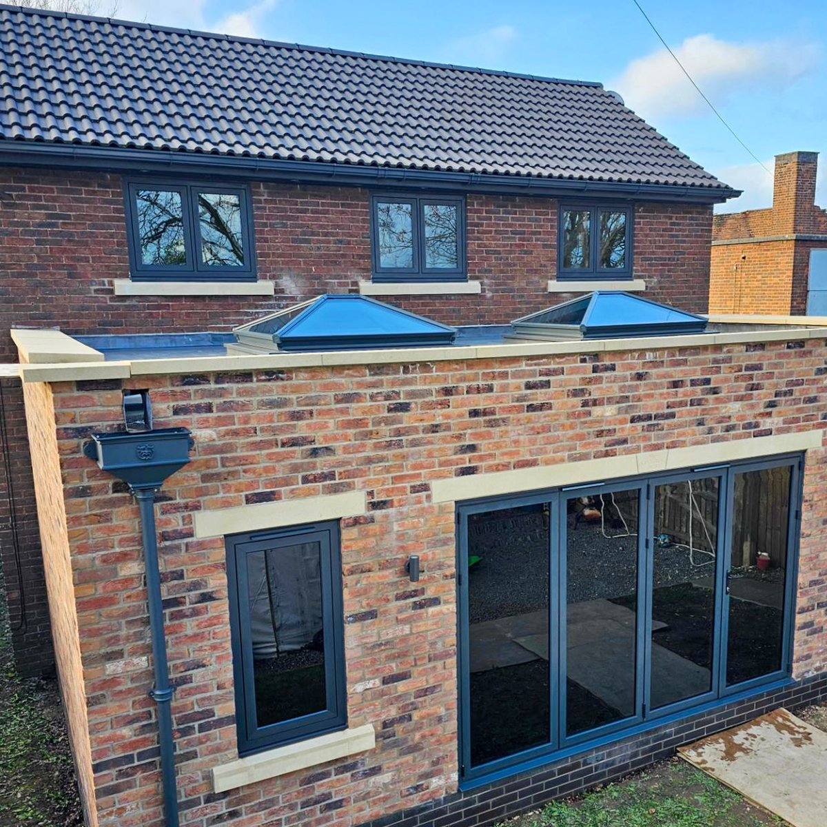 Obsessed with dark grey? 🩶 We are too! Check out this fantastic extension featuring a #Korniche Roof Lantern & Bi-folding Door combo in sleek, anthracite grey with dark grey anti-sun glass and matching windows to complete the look. #anthracitegrey #extension #bifoldingdoors