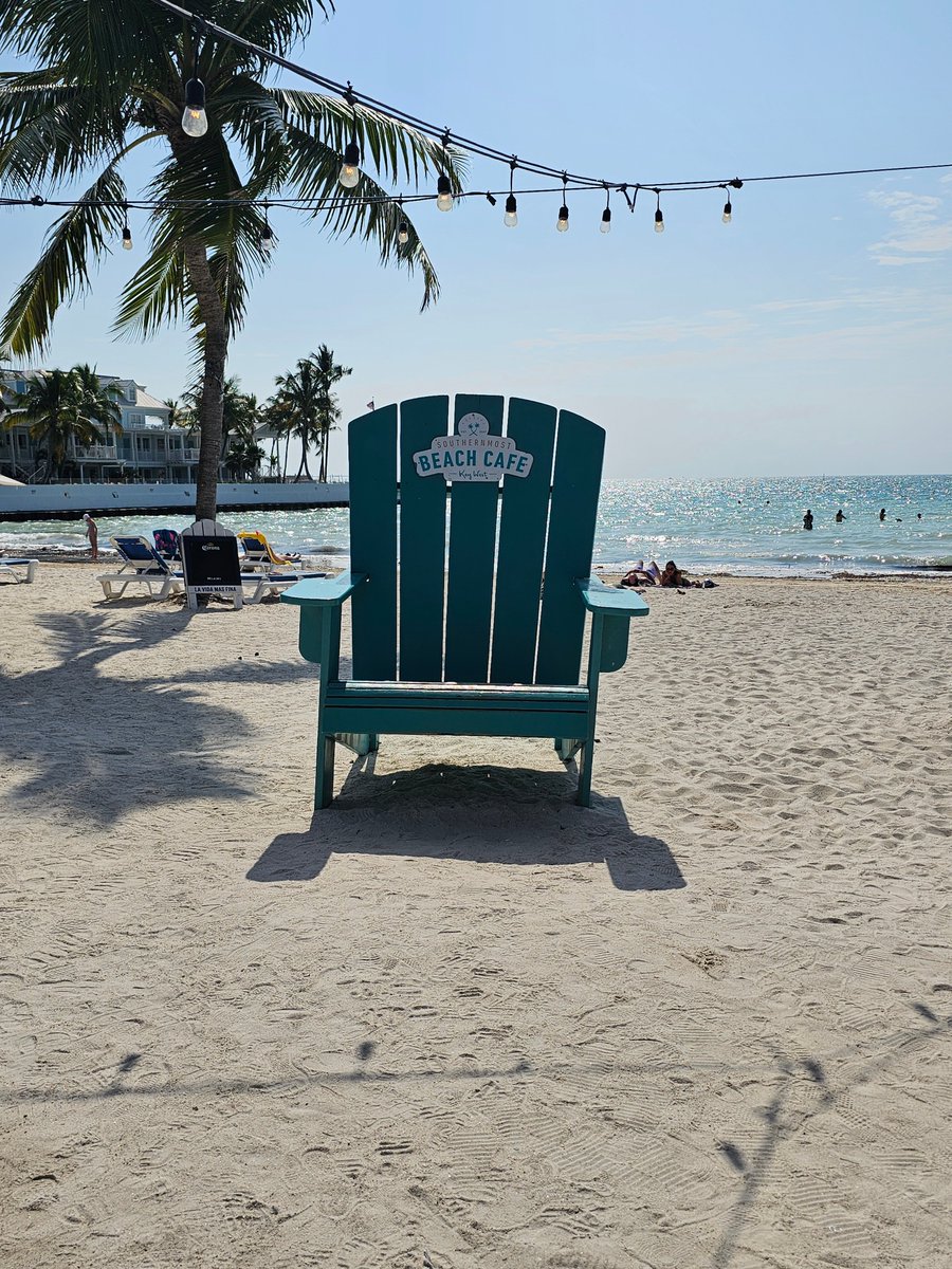 Enjoying the serene morning vibes at the Southernmost Beach Cafe in Key West. 🌅 Who's captured a moment in the big blue chair on the beach? Share your pics! 🏖️ #SouthernmostBeachCafe #KeyWest #IslandLife #BeachVibes #MorningBliss #OceanViews 🌊