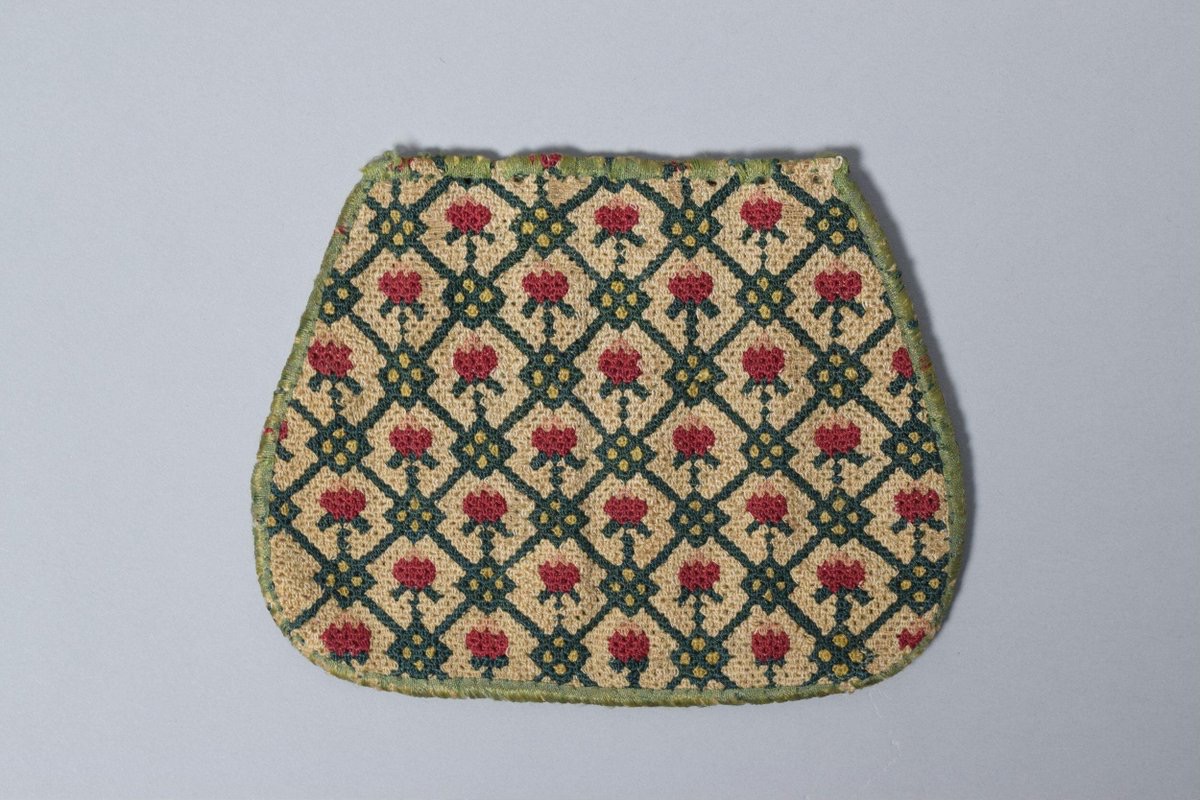 Bag, of embroidered linen, made in Britain, 1675-1700. It once had a drawstring. (Victoria & Albert Museum, London)