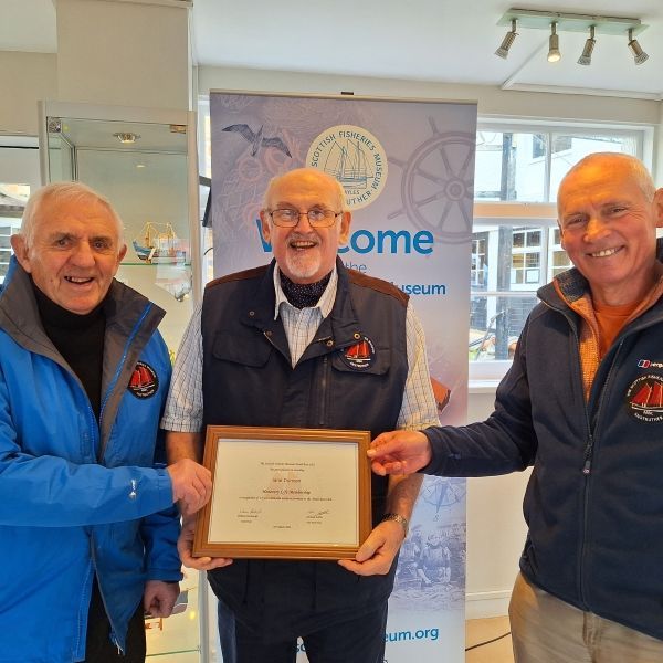 Recognition for Iane Duncan. On Saturday 20th April, 2024 Iane Duncan (centre) , who has been Secretary to the SFM Model Boat Club since its formation in 2008, was presented with a certificate awarding him Honorary Life Membership of the Club. Congratulations Iane!
