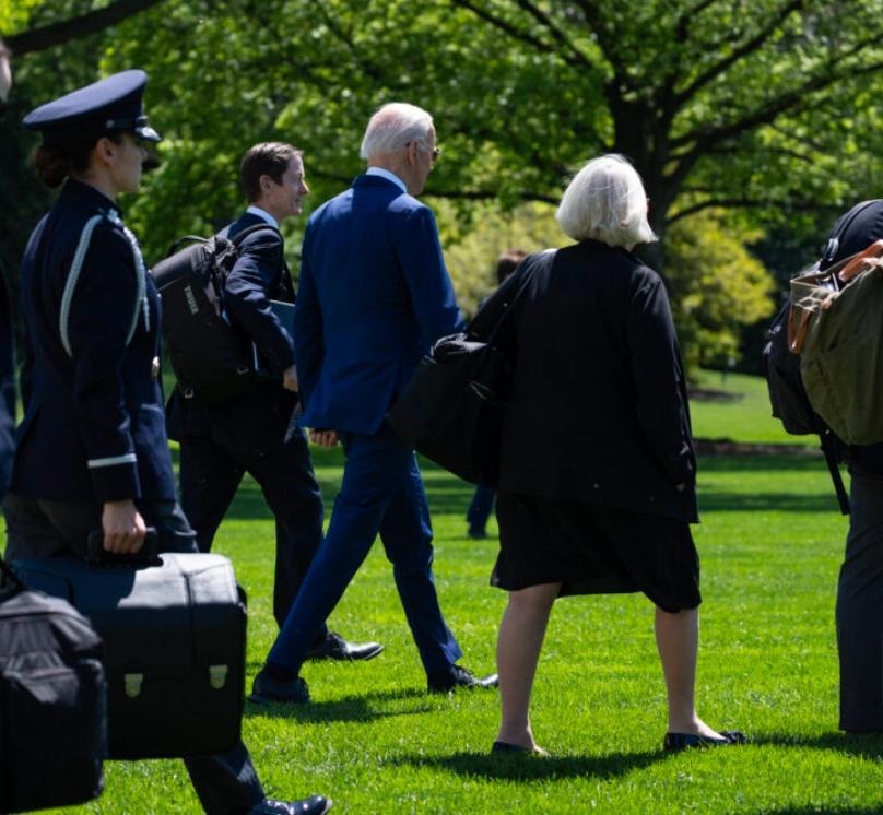 Instead of walking across the South Lawn to and from Marine One by himself, he’s now often surrounded by aides. The visual effect is to draw less attention to the 81-year-old’s halting and stiff gait.