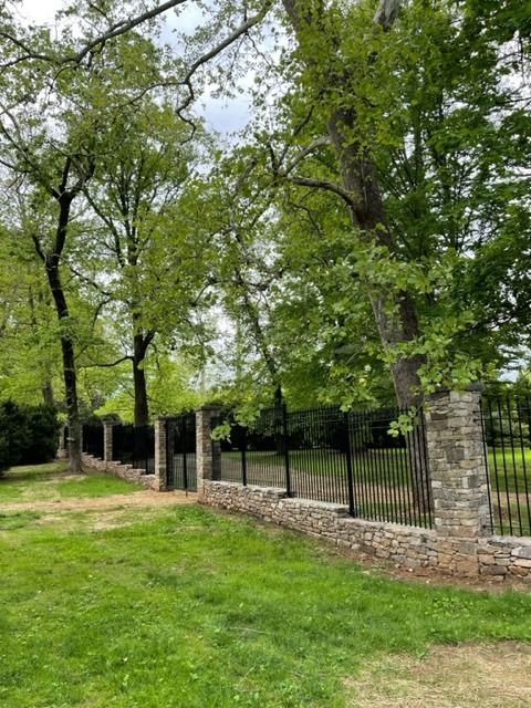 Adding our iron fencing with this beautiful rock wall and pillars elevates the elegance of this already stunning property. 

#IronFenceShop #ironfence #ironfencing #elegant #curbappeal #rockwall #fencing #backyard