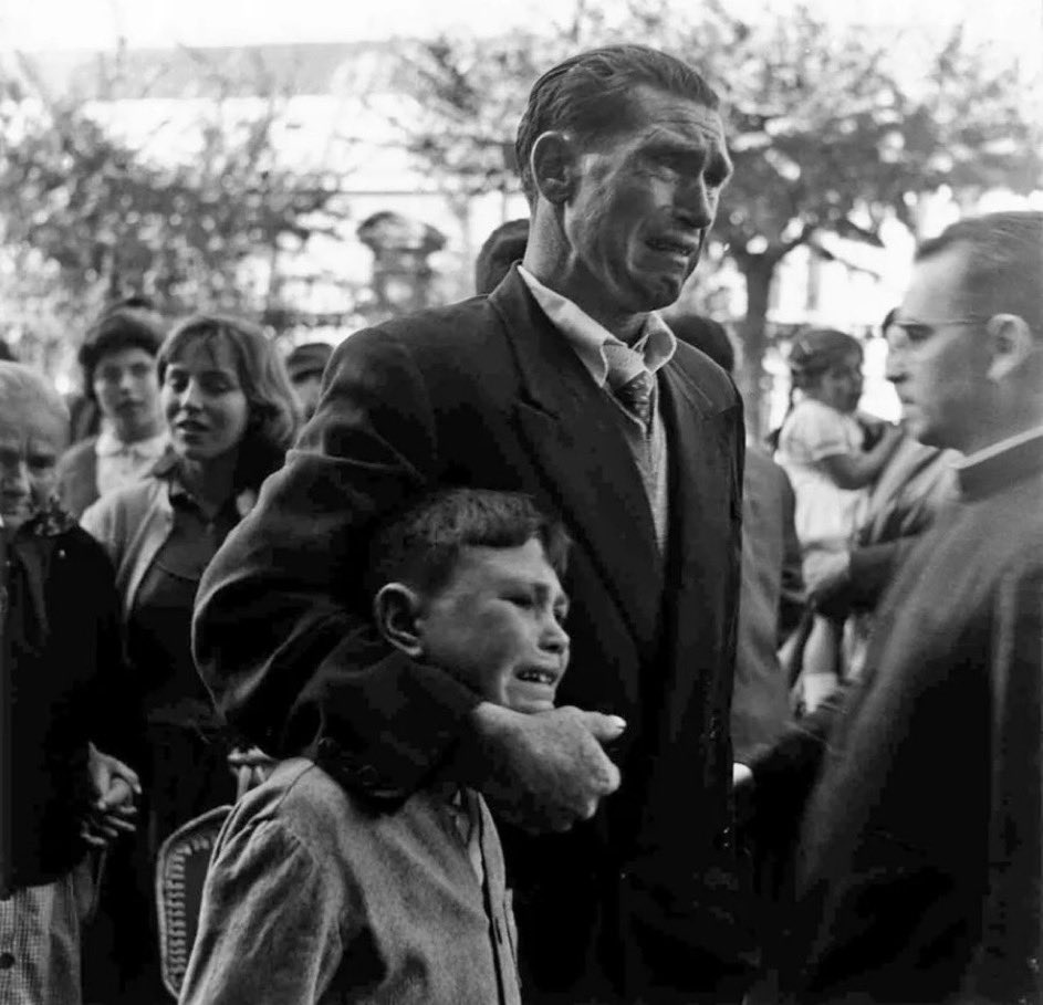 Father and son crying as they say goodbye to their relatives who are boarding a boat to Buenos Aires in search of a better life during the economic hardship in Spain, 1957.