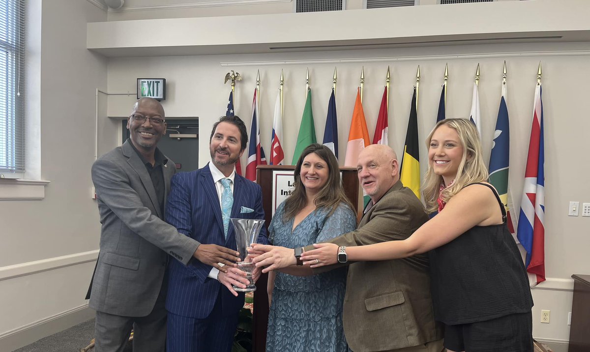 MikeRoebuck1's tweet photo. Another great moment in LCVC’s 50th anniversary!  We received the International Achievement Award from Le Centre International yesterday.  @BenBerthelot and board members pictured, plus staff photo with award #lafayettela @LafayetteTravel https://t.co/ICS9S8zvk4