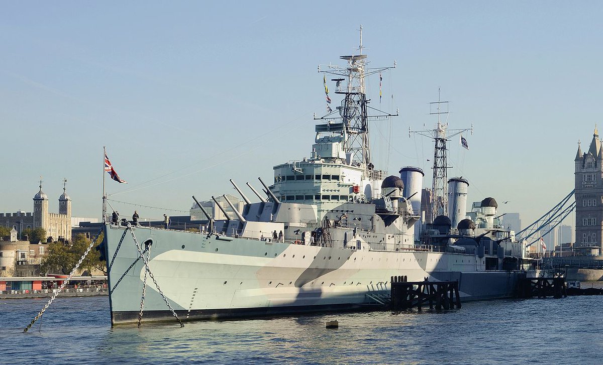 HMS Belfast, one of the last surviving light cruisers. She carries 12 6-inch guns and displaces 11,553 tons – 'light' in World War II referred to gun size, not displacement. Photo from 2013. Dazzle naval camouflage.