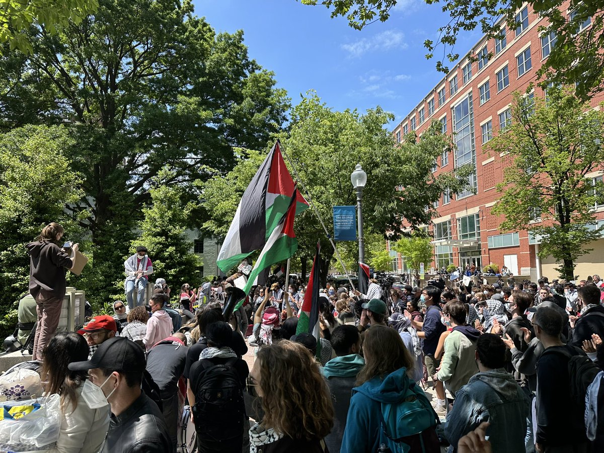 An organizer at GWU University Park reminds protesters to cover their faces & not talk to media. @NEWSMAX