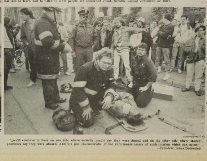 Me unconscious and attended to by paramedics, Univ Michigan, 10/6/88, at a student protest protesting the new policy restricting protests. Technically I was not protesting; I was reporting on the protests for @michigandaily. The cop in the sunglasses did that to me. And others.