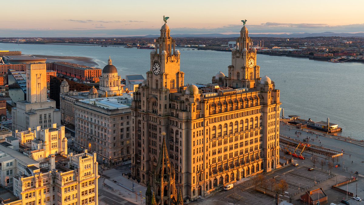 The low evening sun casts a golden glow over #Liverpool's waterfront.
