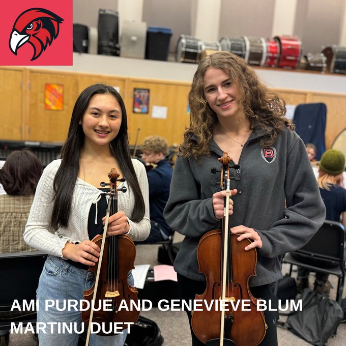 Two orchestra students pose for a photo