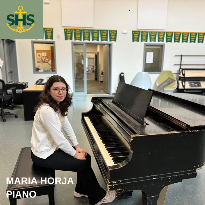 Sehome student seated at piano in music classroom