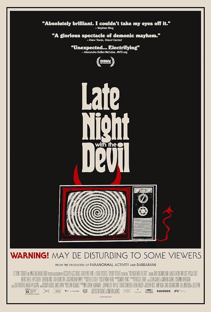 Late Night With The Devil poster. #TheHorrorReturns #TheHorrorReturnsPodcast #THRPodcastNetwork #Horror #HorrorMovies #HorrorTelevision #HorrorSeries #HorrorPodcast #HorrorFamily #MutantFam #LateNightWithTheDevil #DavidDastmalchian #ColinCairnes #CameronCairnes #IFCFilms