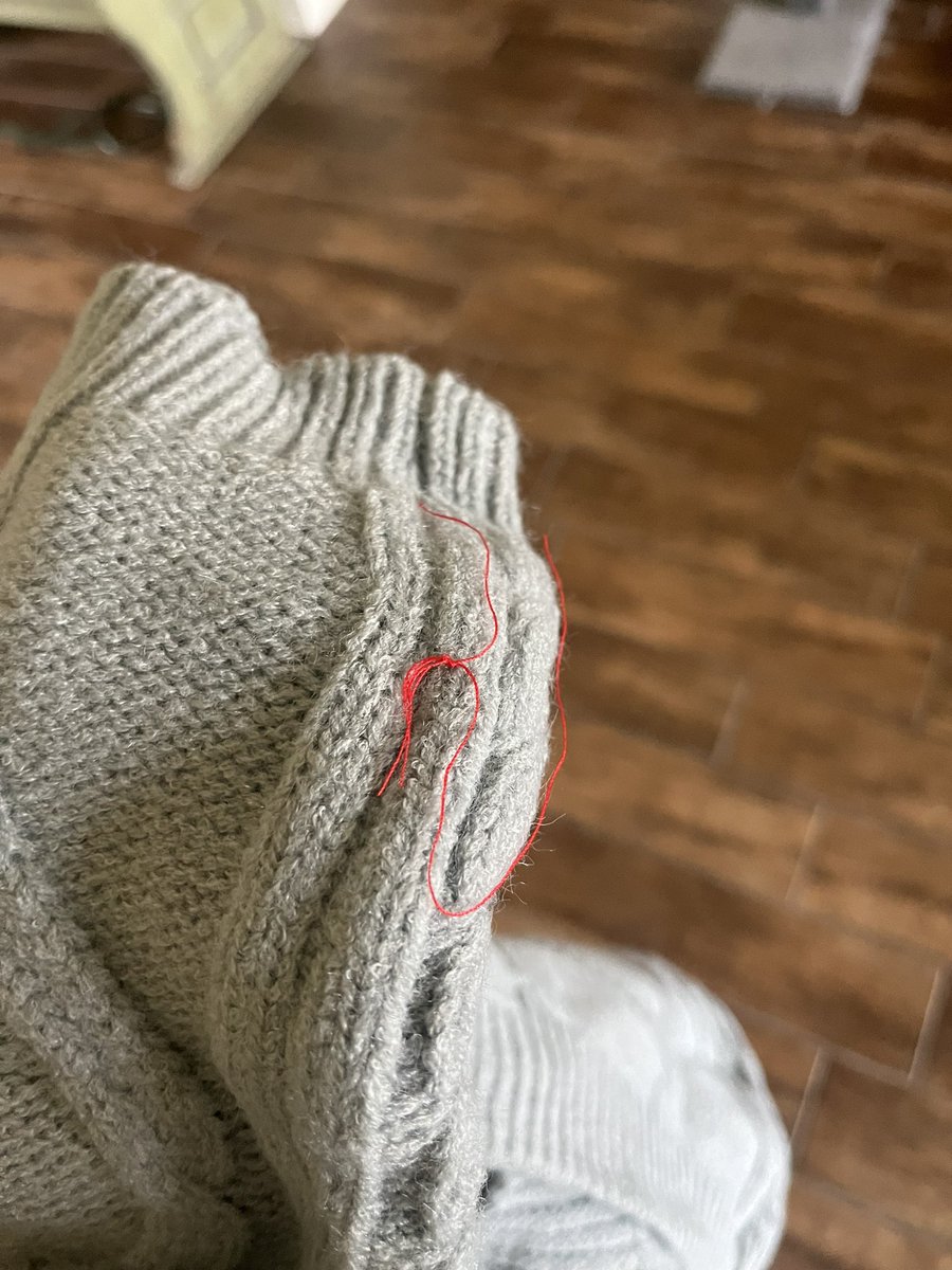 red string on my ttpd cardigan when i opened it, WHAT DOES IT MEAN??