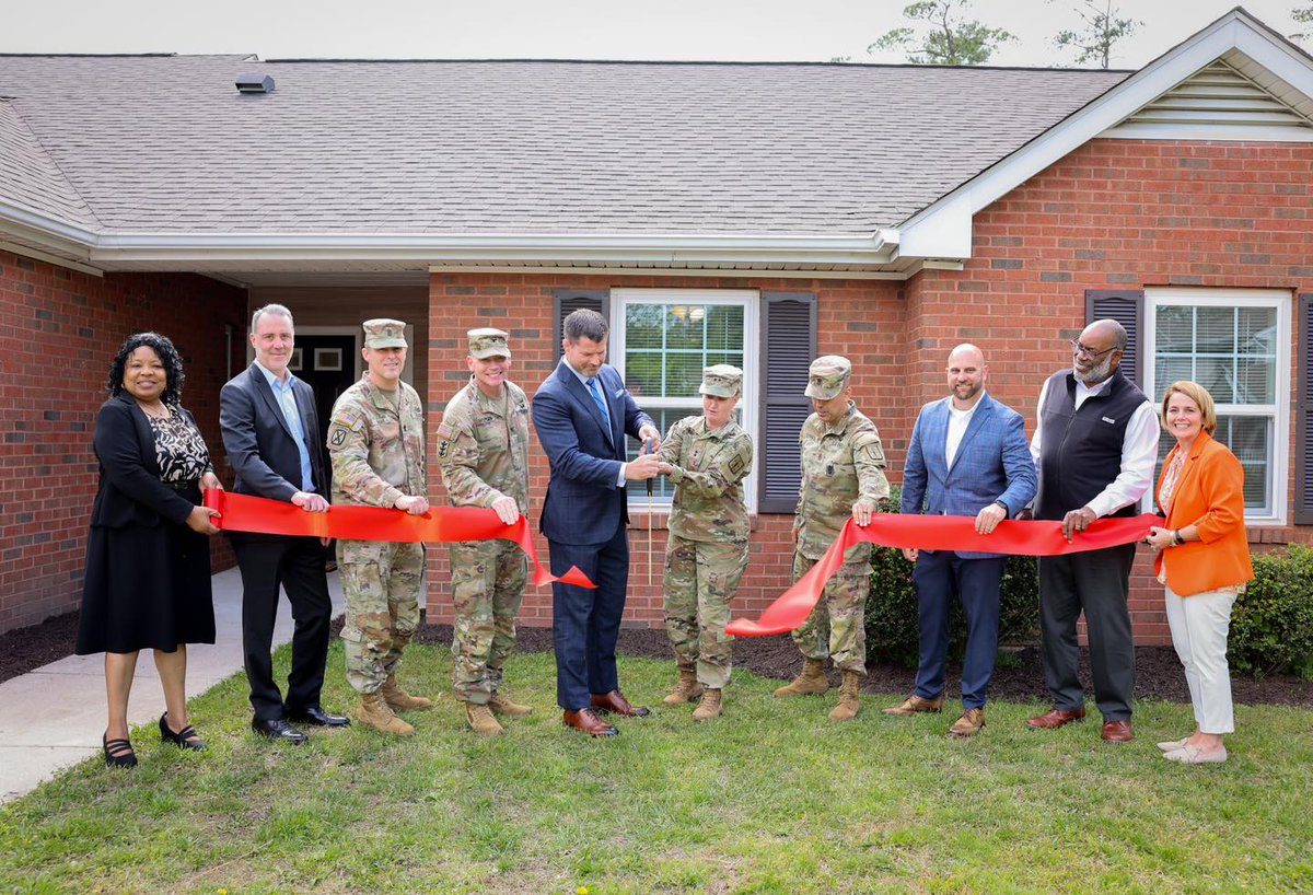 FGAV Garrison and CASCOM leadership stood alongside reps from Hunt Military Communities and Gregg-Adams Family Housing Thursday to cut a ribbon together in celebration of a completed Harrison Villa housing area renovation project while onlookers cheered.