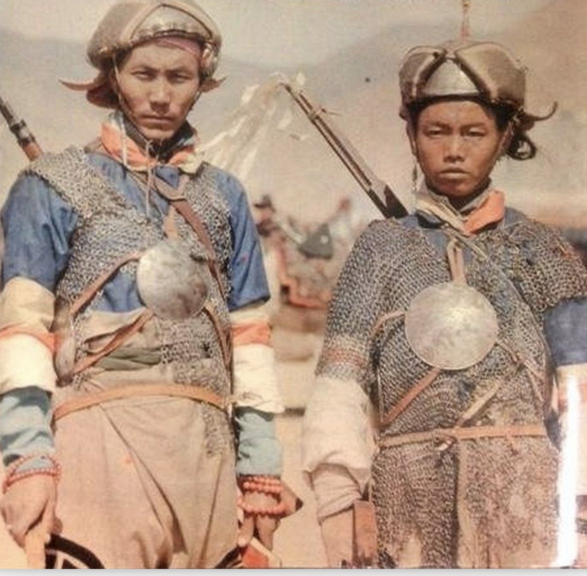 Tibetan warriors with metal helmets, mirror armor and matchlocks. Circa 1910