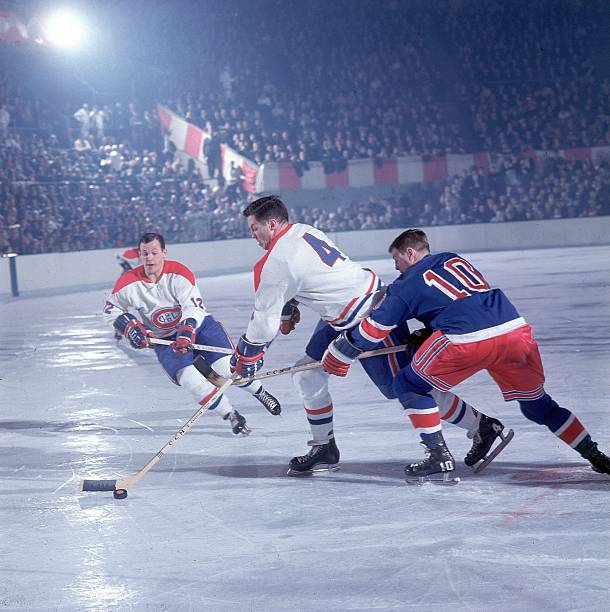 1967 Semi-Finals. Last year of the 'Original 6.' Jean Béliveau makes a move to get around Earl Ingarfield as Yvan Cournoyer swoopes in for support.