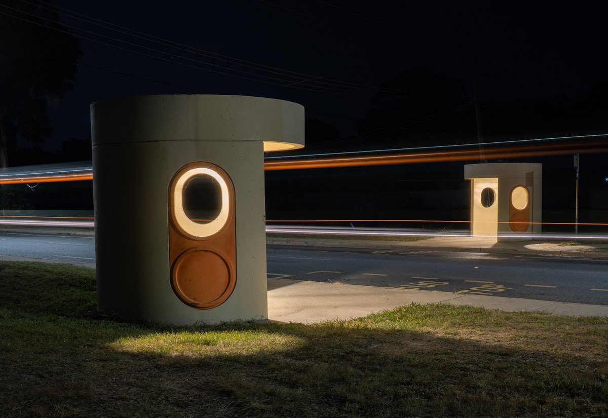 A bus passes between two shelters in Barritt Street Kambah